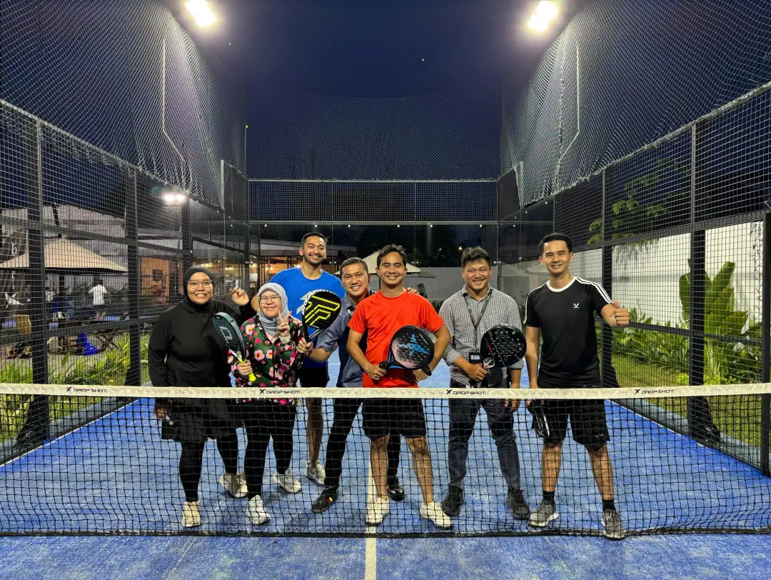 A group of players on court at night
