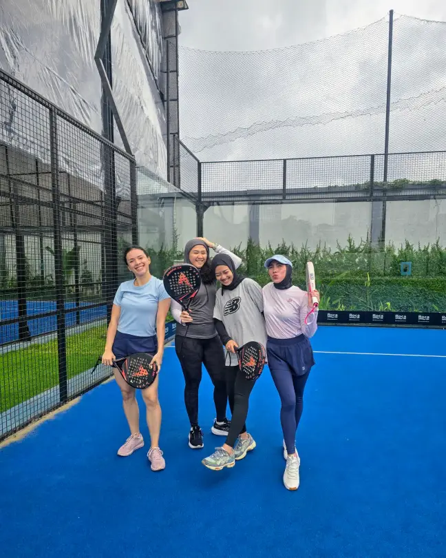 Four players posing on court