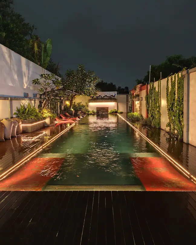 The swimming pool lit at night